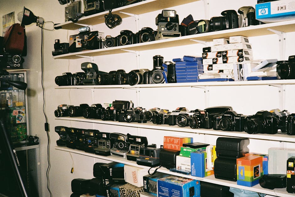 A variety of vintage cameras on display in a cluttered photography shop.